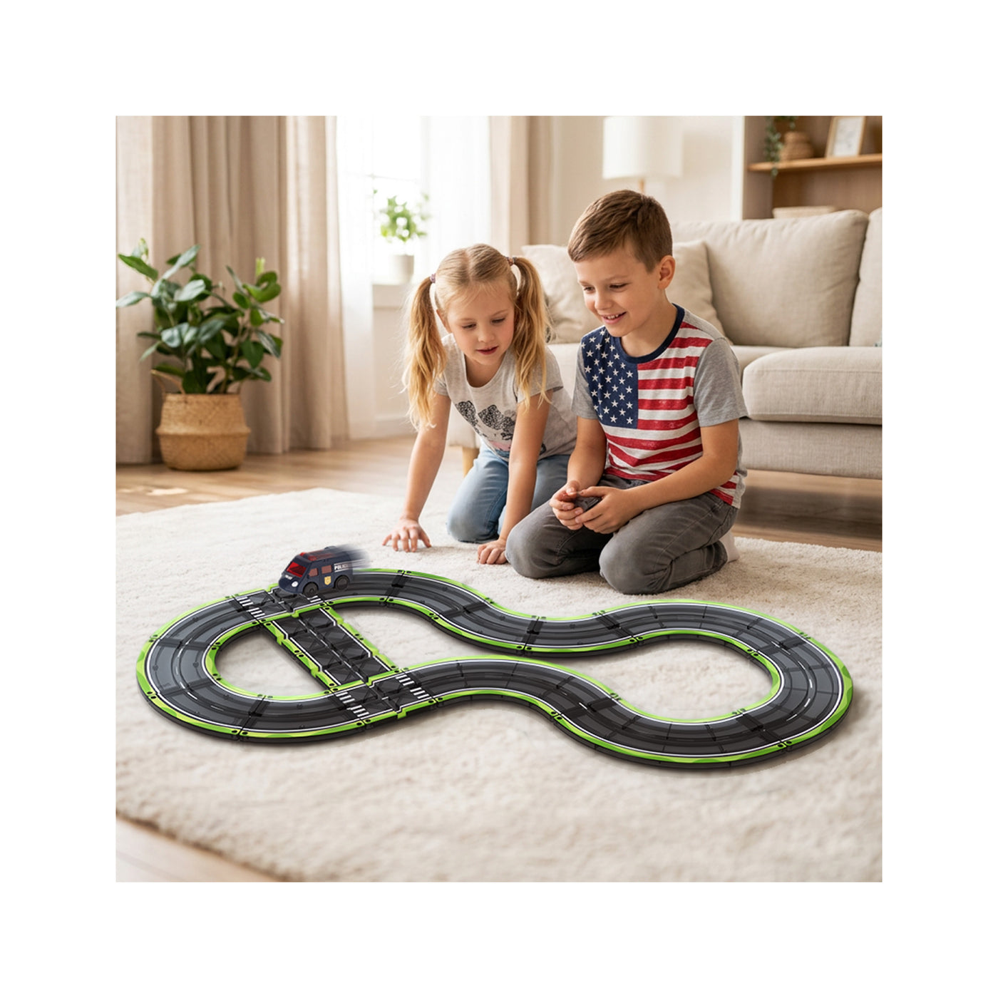 Two children kneeling on a rug in a living room, watching a toy police car drive around a magnetic race track.