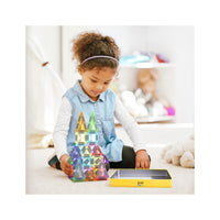 A young girl builds a colorful translucent tile castle next to an open yellow EverPlay storage tin.