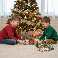 Two boys playing on a rug with Christmas-themed magnetic tile sets in front of a decorated Christmas tree.   
