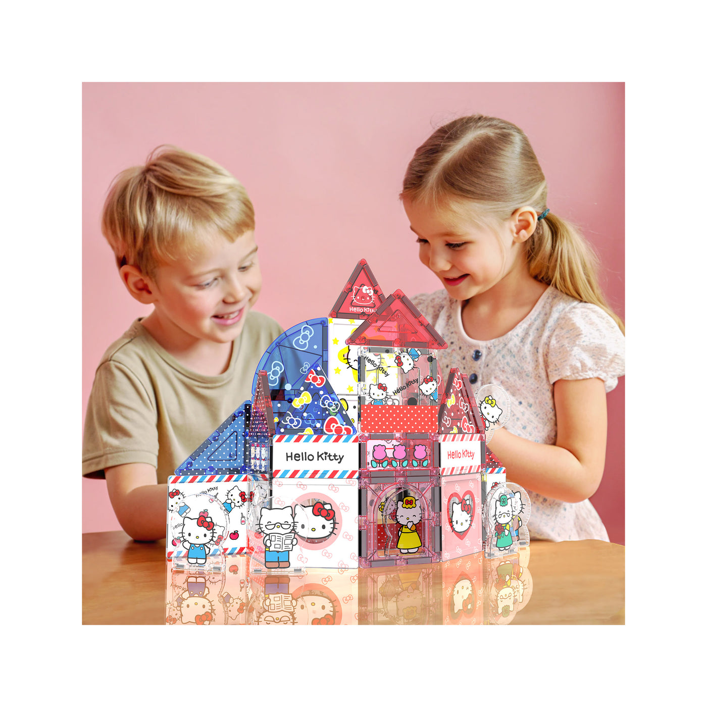 Infographic of a boy and girl playing together with a built Hello Kitty magnetic tile house set on a wooden table.