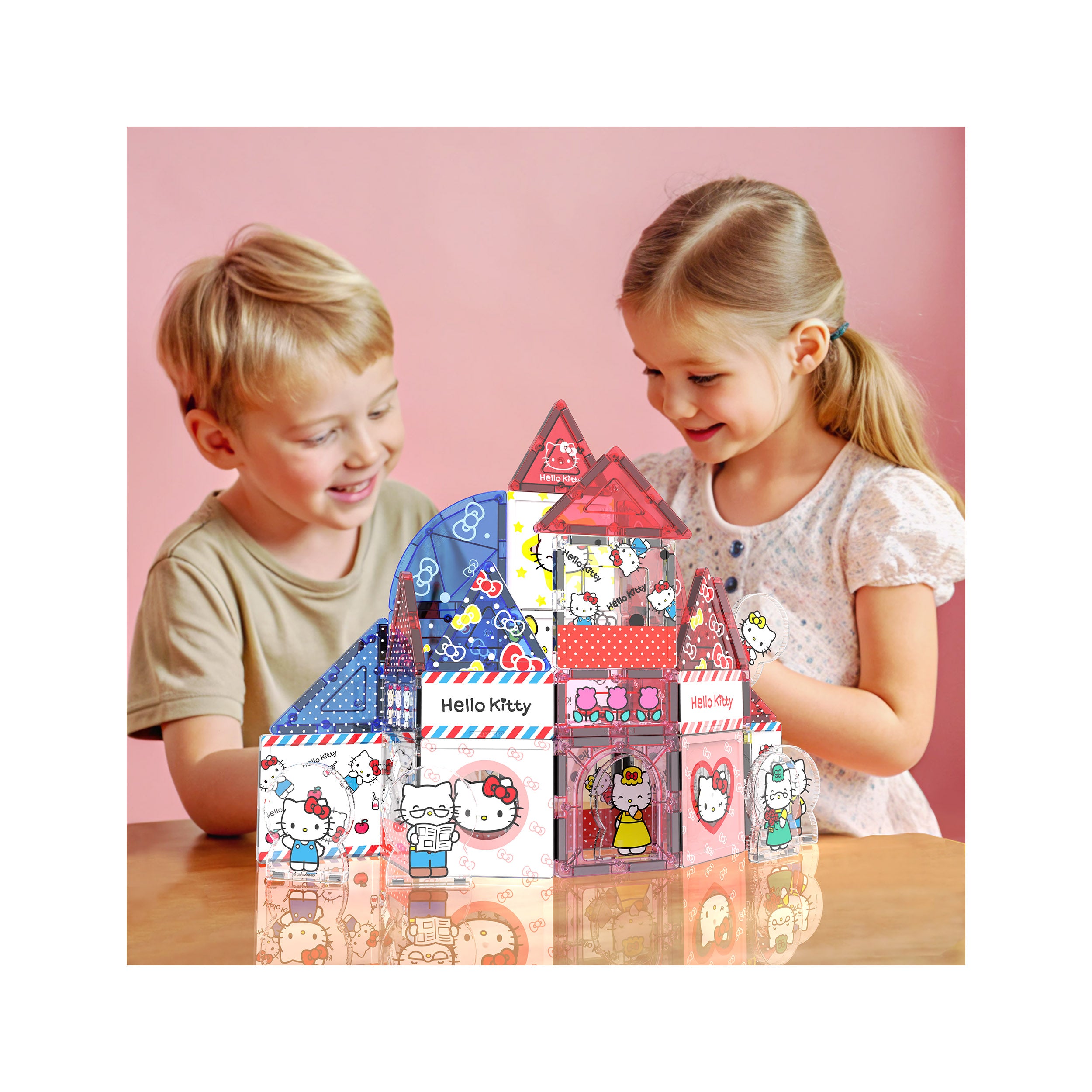Infographic of a boy and girl playing together with a built Hello Kitty magnetic tile house set on a wooden table.