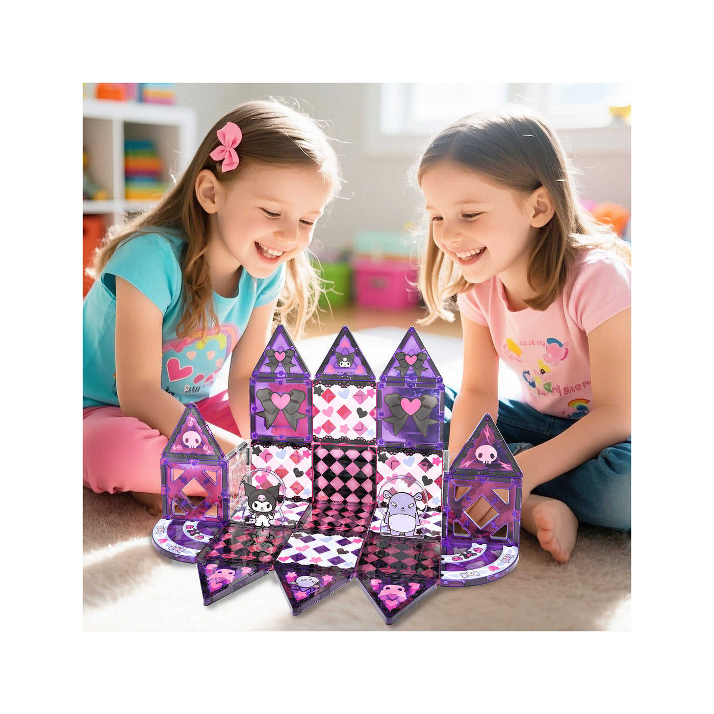 Two girls smiling as they build a purple and black Kuromi magnetic tile castle on a carpet.