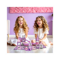 Two laughing girls with a purple Kuromi magnetic tile castle and slide structure.