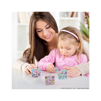 Mother and daughter playing with Hello Kitty magnetic puzzle cubes at a table.