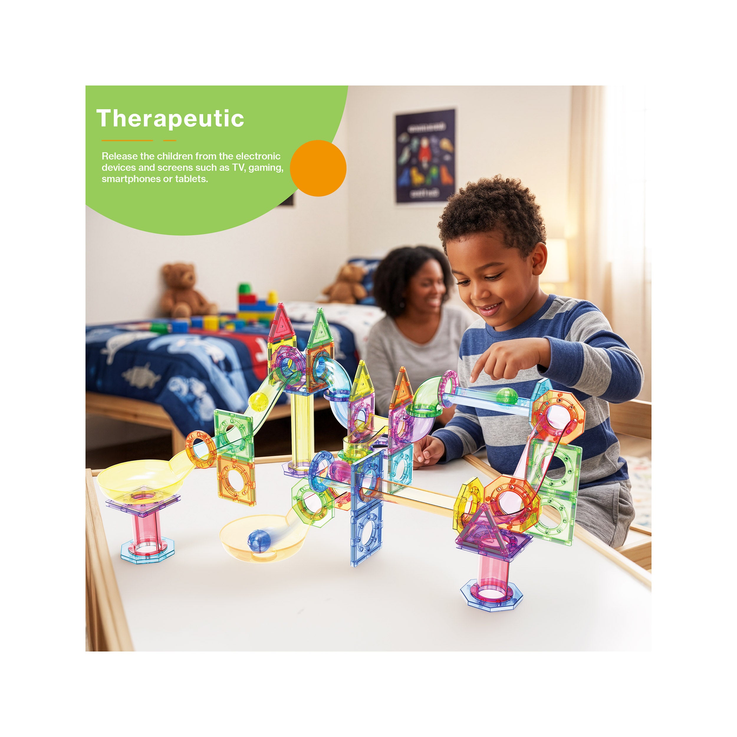 Boy playing with an assembled magnetic marble run set on a table with a "Therapeutic" feature banner in the corner.