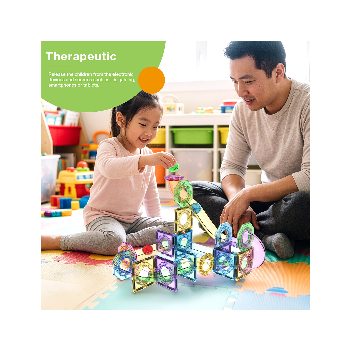 Father and daughter building a magnetic marble run on a play mat with a green "Therapeutic" banner.