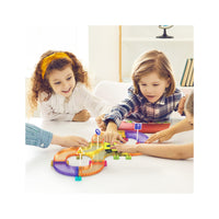 Children gathered around a table playing with a colorful figure-eight magnetic race track set and toy car.