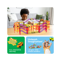 Boy playing with a multi-level magnetic race track structure above feature panels highlighting creative play.