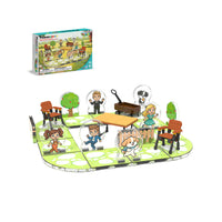 A children's outdoor-themed board game set displayed on a white background, including a colorful game board, several illustrated character figures, multiple chairs, a small cart, and the retail box shown in the upper left.