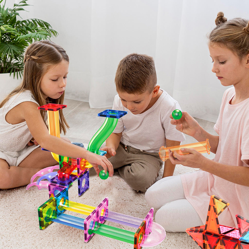 Kids playing with a marble run toy, part of the STEM motion bundle