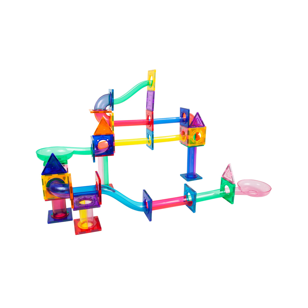 An assembled multi-level magnetic tile marble run structure featuring translucent pipes, slides, and triangle peaks.